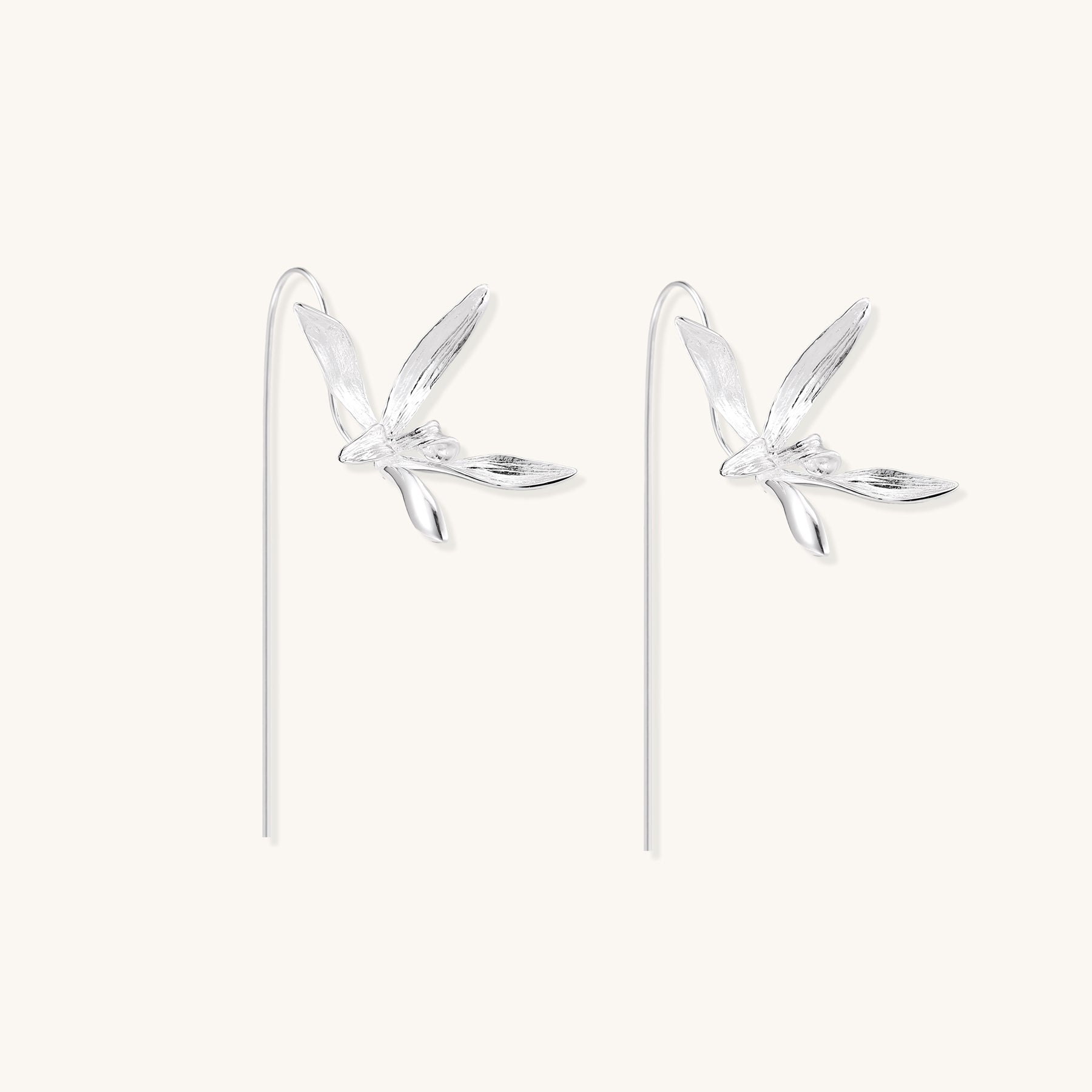 Delicate sterling silver flower earrings with long threader posts and five-petal design on white background.