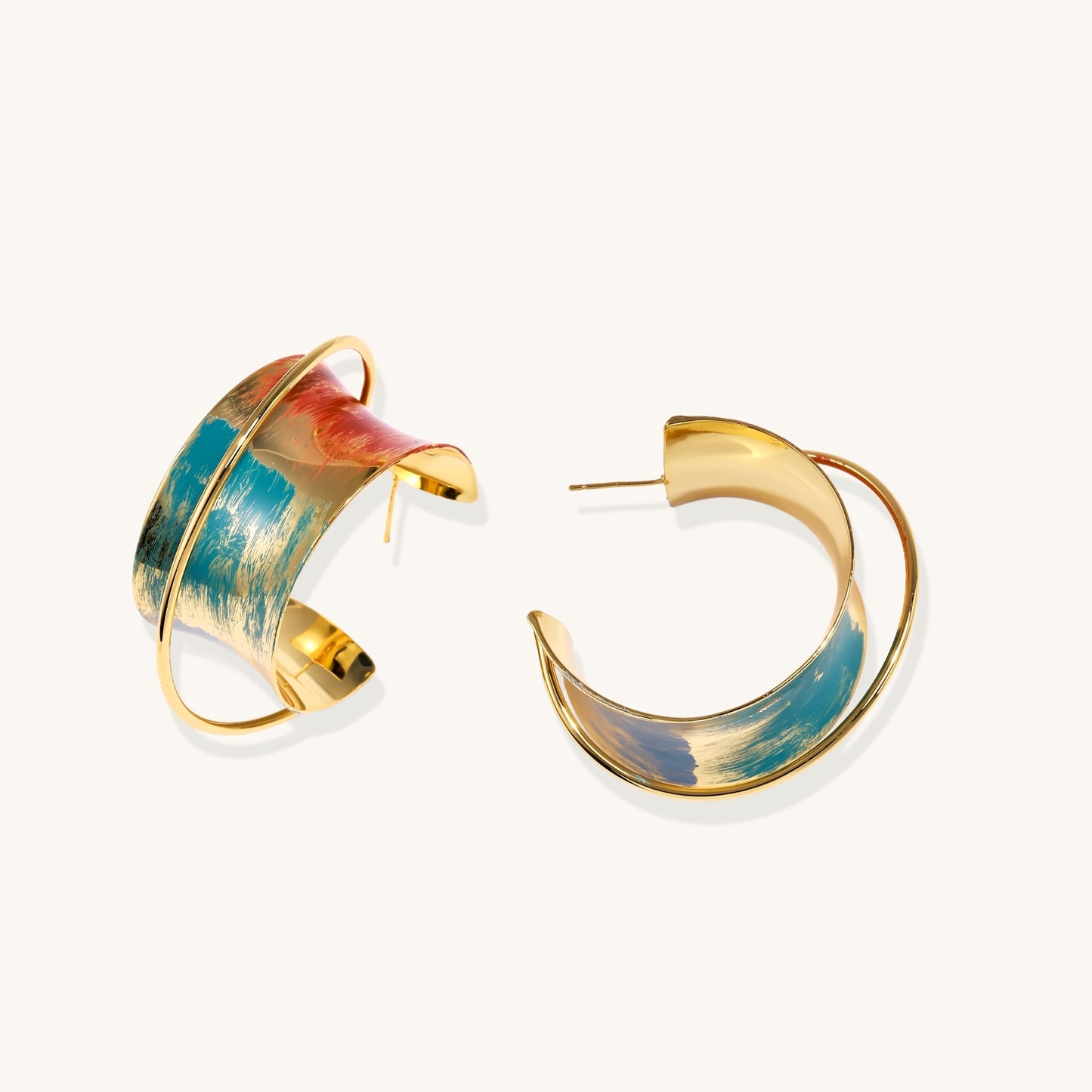 Gold-plated hoop earrings with colorful enamel brushstroke patterns in turquoise, coral, and gold tones