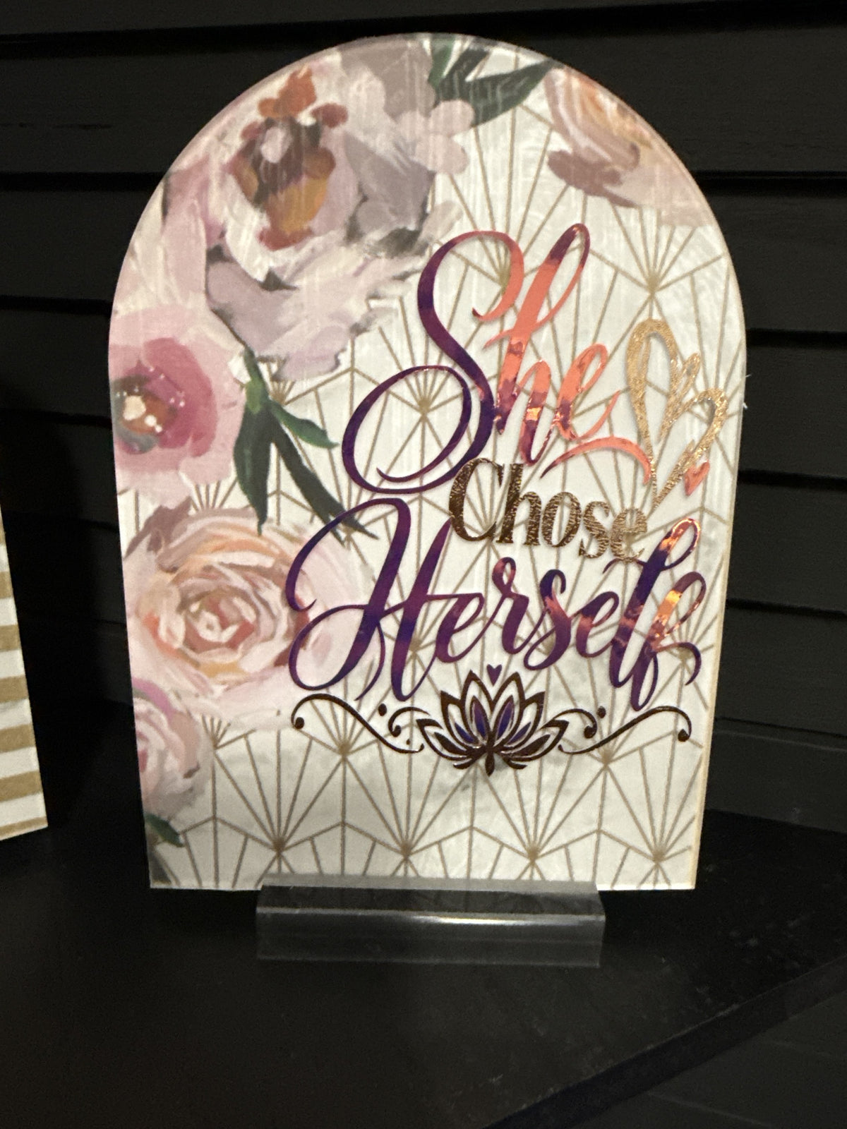 She Chose Herself arched acrylic plaque: blush and mauve watercolor peonies on white with gold geometric lines, iridescent foil script, copper glitter heart and lotus, on a clear acrylic stand